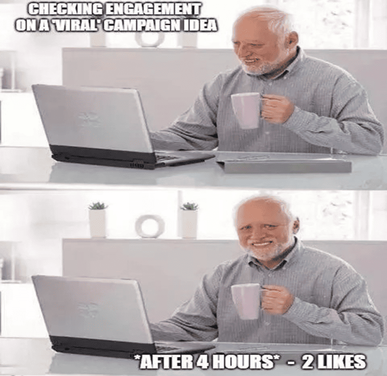 A guy holding a mug and using a laptop